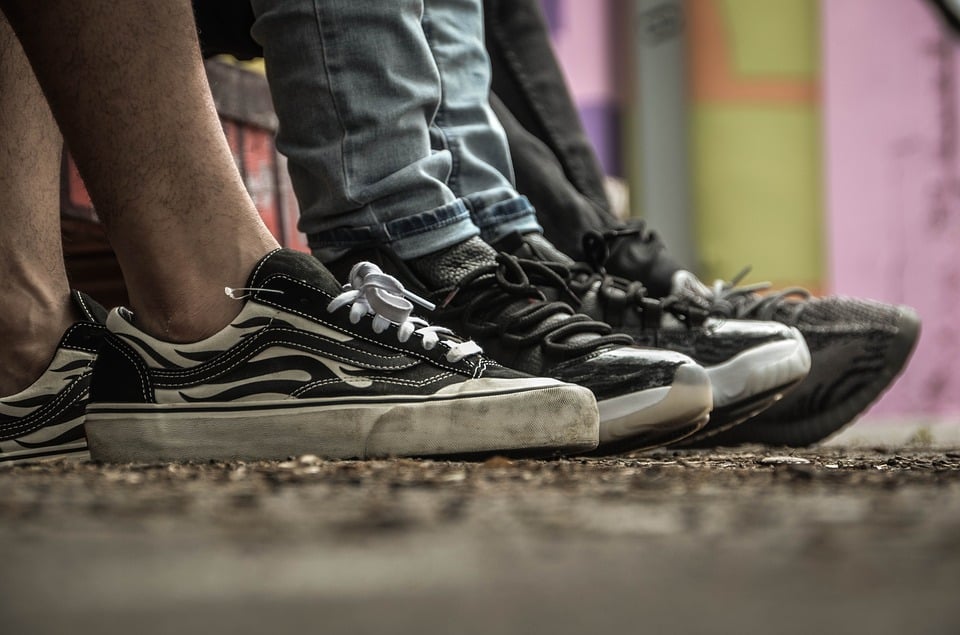 Photo of scuffed, worn shoes to show diversity, youth, and action.